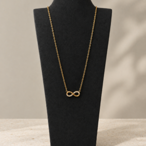 Gold tone infinity necklace with clear stones in stainless steel by Nagina Jewellery